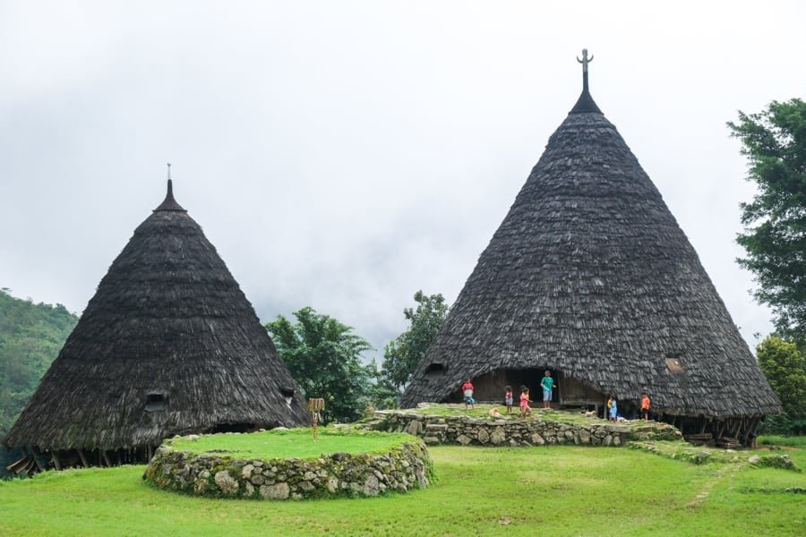 Wae Rebo Mbaru Niang traditional houses Flores Indonesia seven cone shaped natural materials Manggarai clearing Himalayas vibe