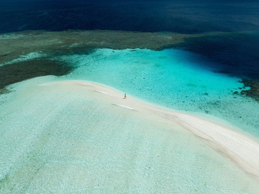 A sandbank in a turquoise lagoon. No crowds. No noise. Just the ocean.