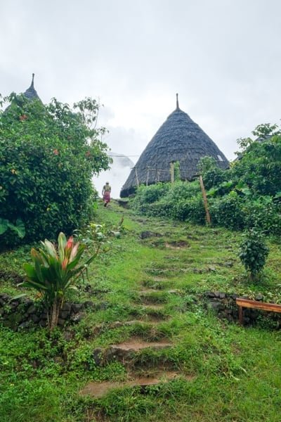 Wae Rebo surroundings Flores Indonesia panoramic rolling green hills valley mist Manggarai highlands Mbaru Niang houses Himalayas vibe